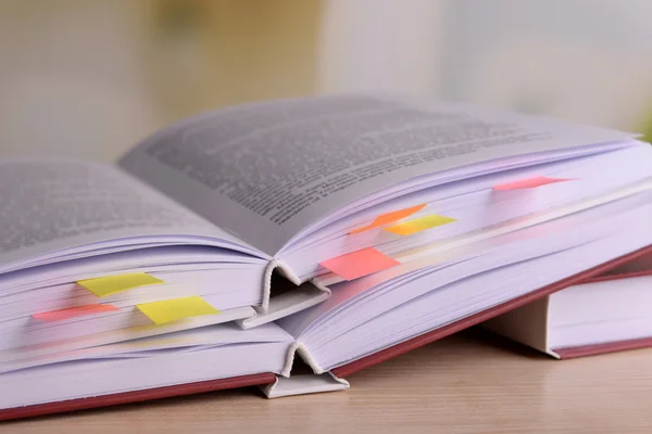 Books with bookmarks on table on bright background — Stock Photo, Image