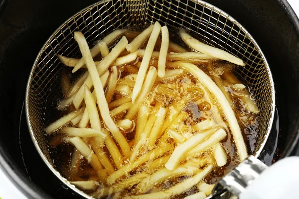 French fries in deep fryer, closeup — Stock Photo, Image