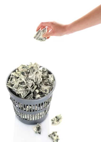 Hand throwing money into trash can isolated on white — Stock Photo, Image