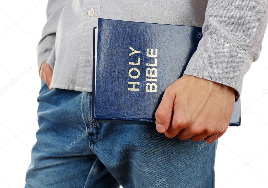 Man holding Bible isolated on white