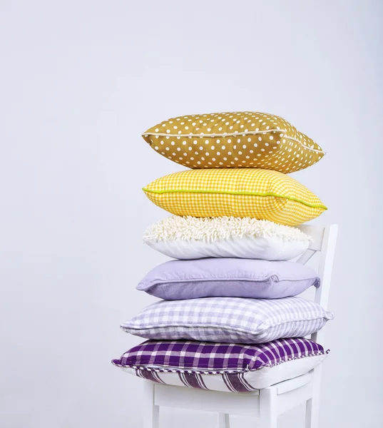 Bright pillows on chair — Stock Photo, Image
