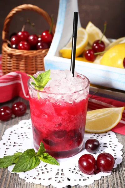 Fresh cold cherry cocktail with mint, ice and lemon — Stock Photo, Image