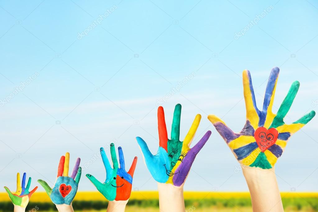 Painted hands on sky background