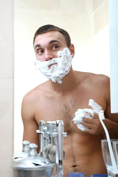 Jongeman scheren zijn baard in badkamer — Stockfoto