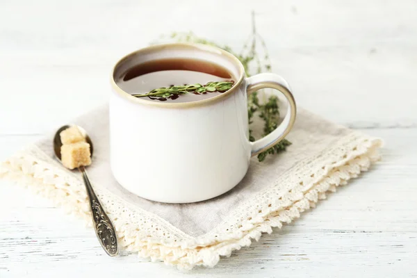 Cup of tasty herbal tea with thyme on wooden table — Stock Photo, Image