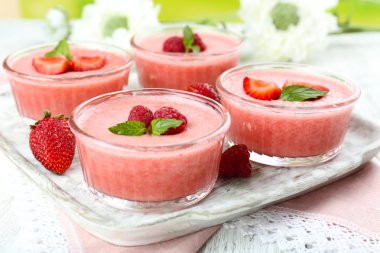 Delicious berry mousse in bowls on table close-up clipart