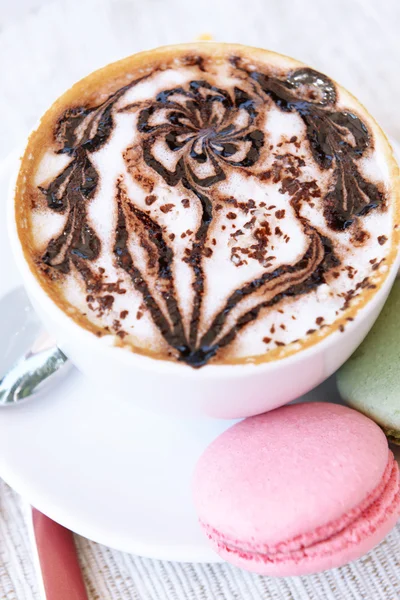 Cup of coffee with cute drawing on table, close up — Stock Photo, Image