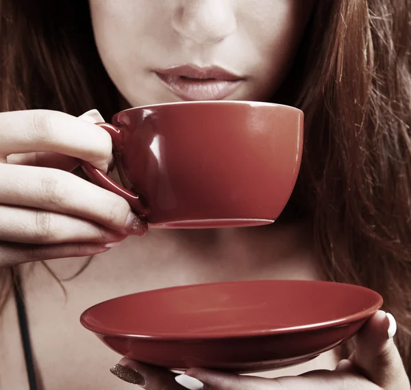 Hermosa joven con taza de café sobre fondo marrón — Foto de Stock