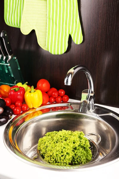 Fresh vegetables in sink in kitchen — Stock Photo, Image