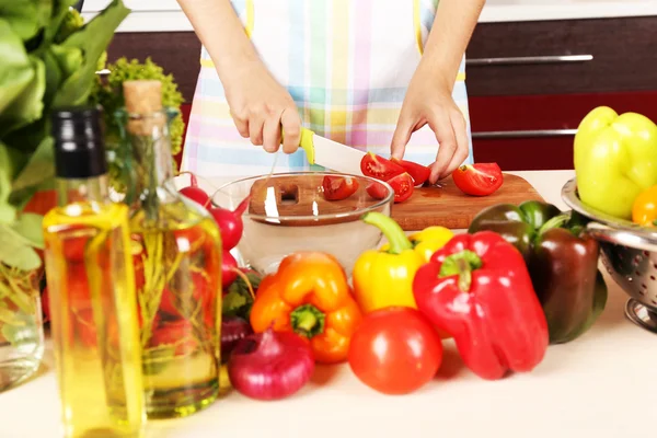 Woman cooking vegetable salad in kitchen — Stock Photo, Image