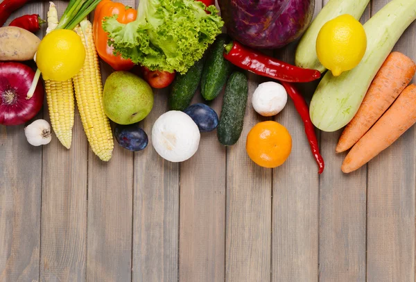 Fruits et légumes frais biologiques sur fond de bois — Photo