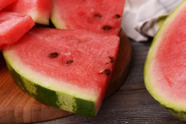 Slices of watermelon on wooden background — Stock Photo, Image