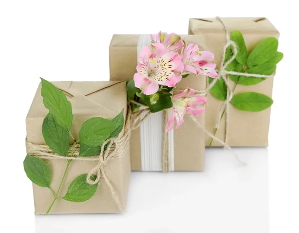 Natural style handcrafted gift boxes with fresh flowers and rustic twine, isolated on white Stock Photo