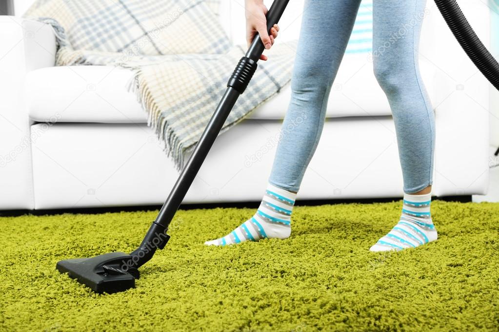 Girl vacuuming in room