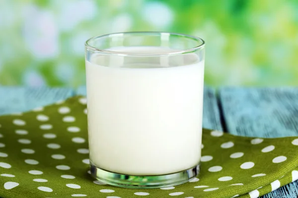 Milk in glass on napkin — Stock Photo, Image