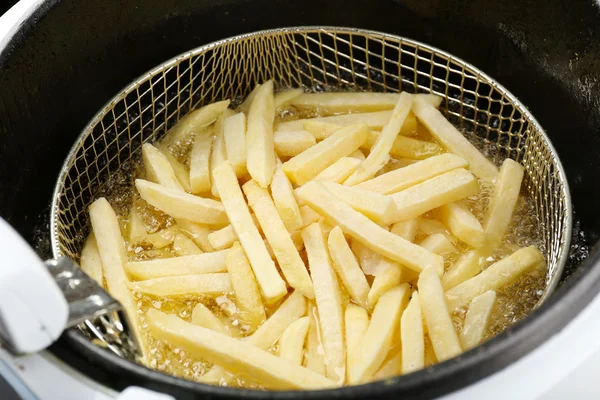 French fries in deep fryer, closeup — Stock Photo, Image