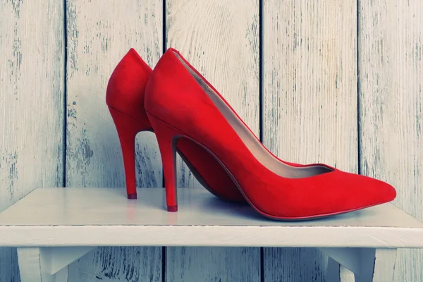 Red women shoes on wooden background — Stock Photo, Image