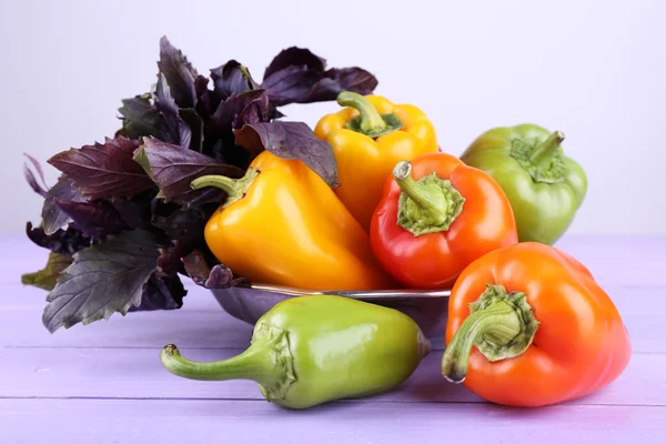 Pepper and basil on wooden background — Stock Photo, Image