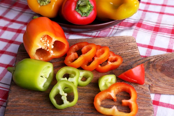 Pepper on plate and on board — Stock Photo, Image