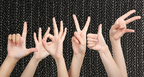 People show different hands signs on textured background — Stock Photo, Image