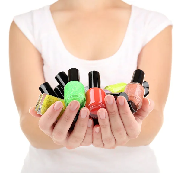 Colorful nail polishes in hands, close-up — Stock Photo, Image