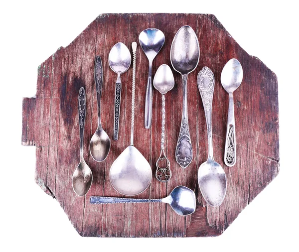 Metal spoons on board — Stock Photo, Image