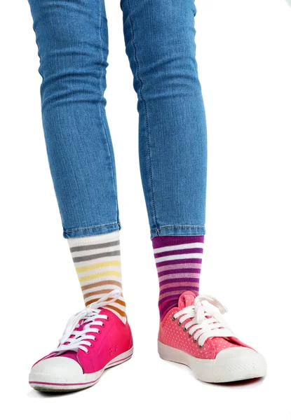 Female legs in colorful socks and sneakers — Stock Photo, Image