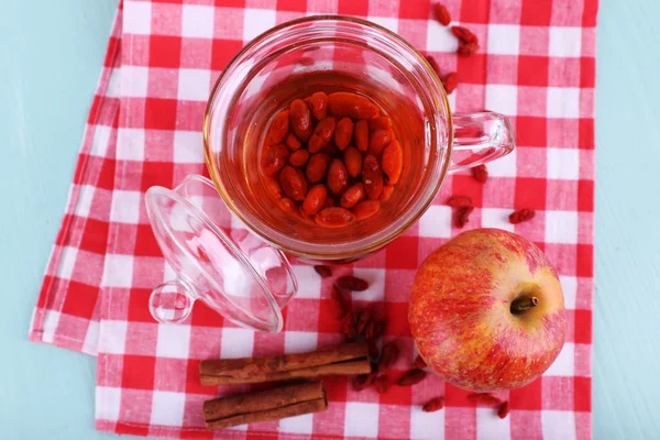 Goji berries and drink in ceramic cup — Stock Photo, Image