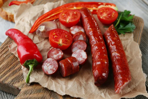 Smoked thin sausages and vegetables — Stock Photo, Image