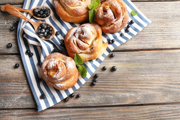 Tasty buns with berries on table close-up — Stock Photo, Image