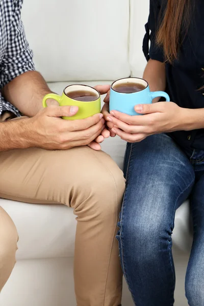 Loving couple with hot drinks — Stock Photo, Image