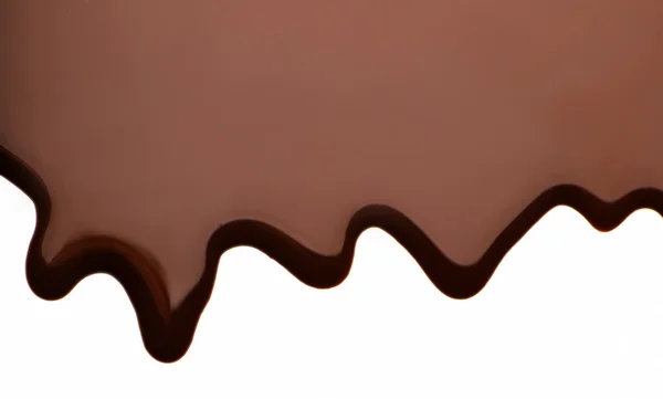 Melted chocolate dripping on white background — Stock Photo, Image