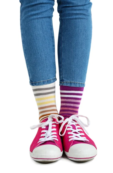 Female legs in colorful socks and sneakers — Stock Photo, Image