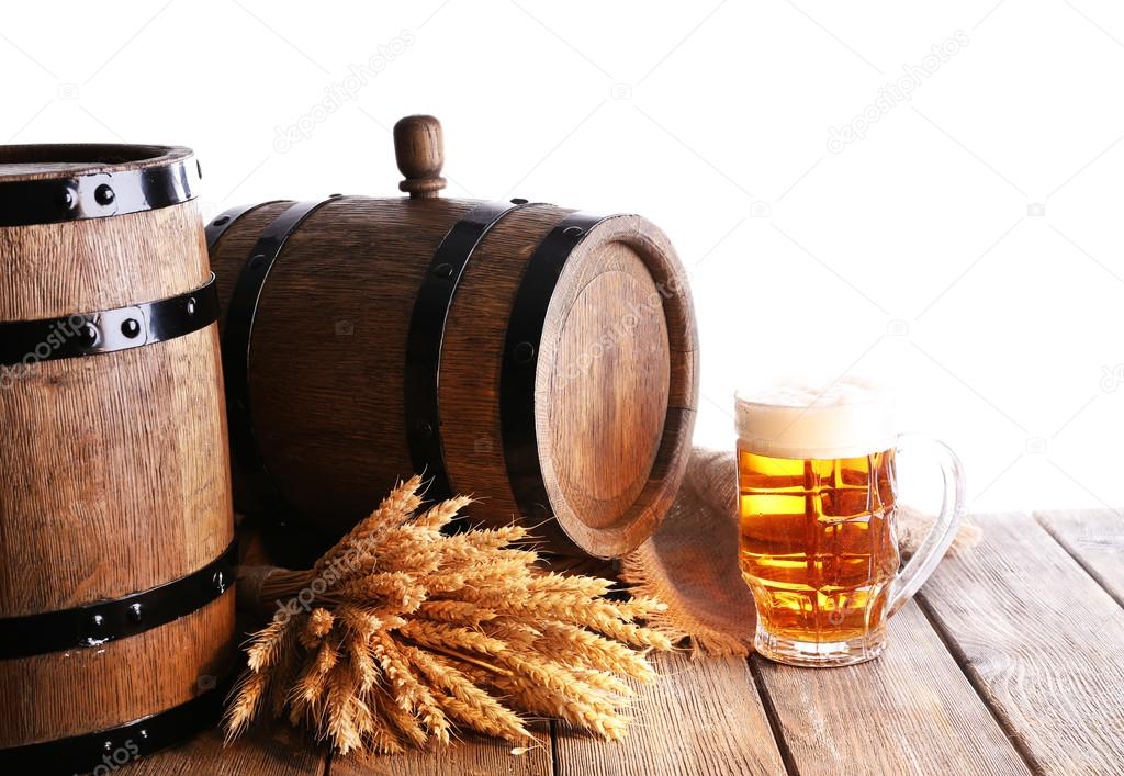 Beer barrel with beer glass on table on white background
