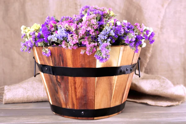 Big wooden basket with fresh flowers — Stock Photo, Image