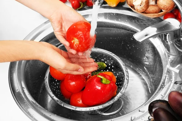 Tangan wanita mencuci sayuran di dapur — Stok Foto
