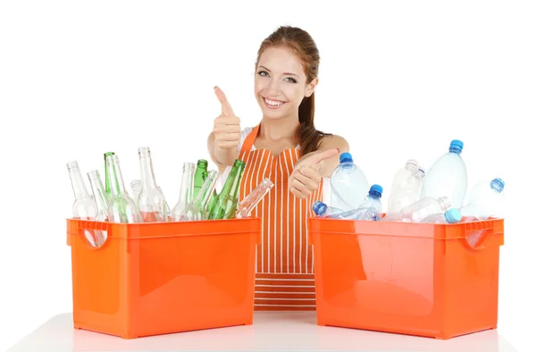 Young girl sorting glass and plastic bottles isolated on white — Stock Photo, Image