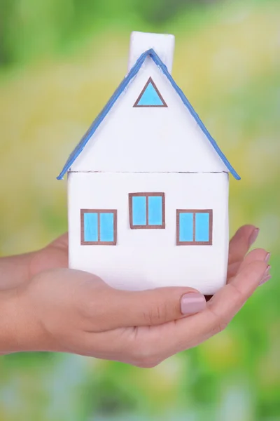 Woman hands with small house — Stock Photo, Image