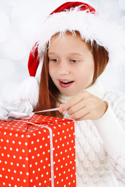 Beautiful little girl with present box on bright background — Stock Photo, Image