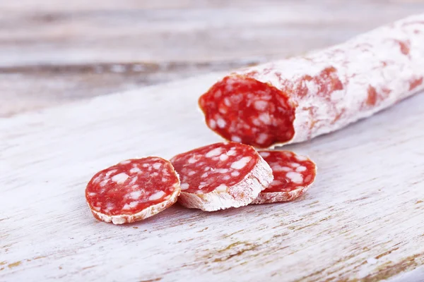 French salami on cutting board on wooden background — Stock Photo, Image