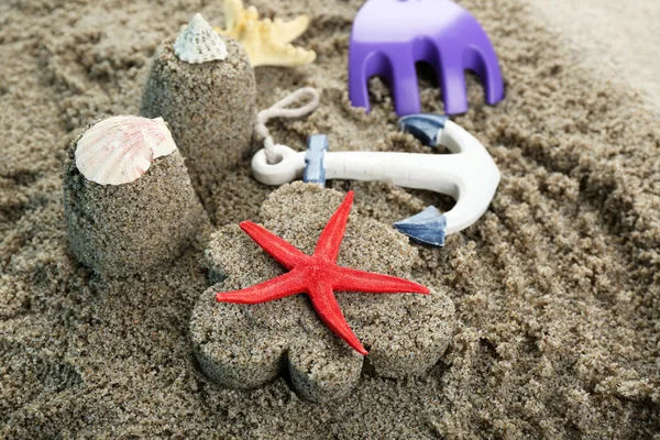 Flower-shaped  and castle-shaped sand, starfish and children toys close-up — Stock Photo, Image