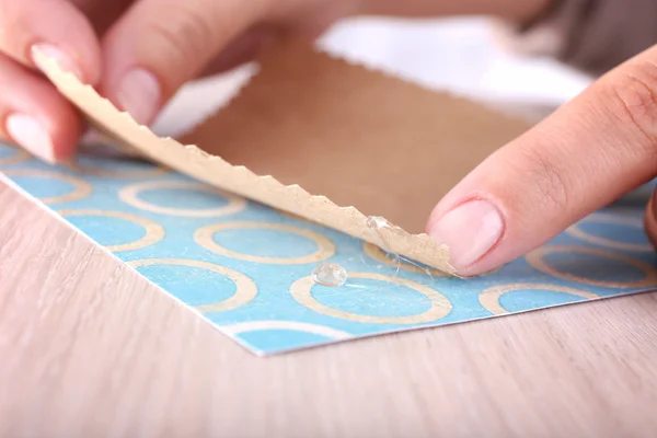 Woman making postcard with glue gun — Stock Photo, Image