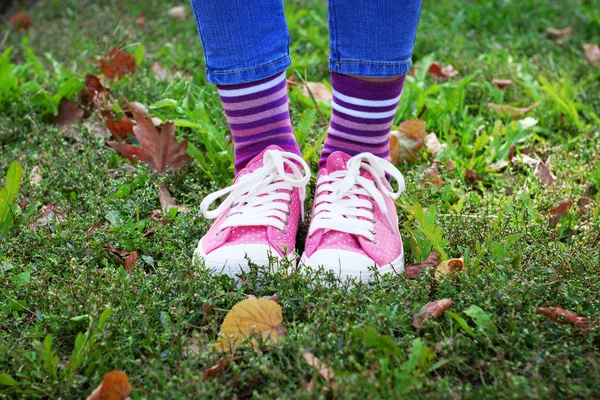 Piernas en calcetines y zapatillas de deporte de colores —  Fotos de Stock