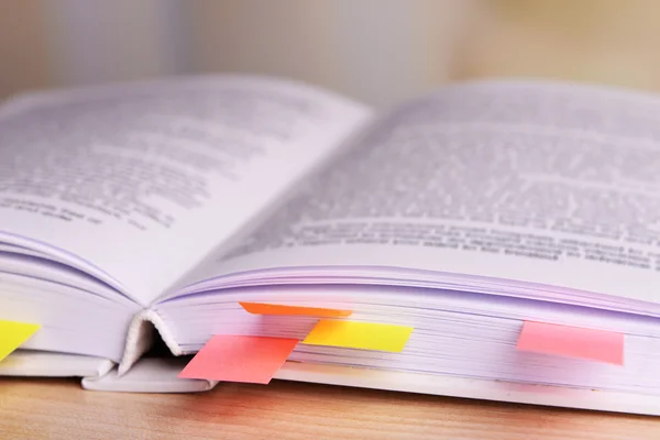 Book with bookmarks on table — Stock Photo, Image