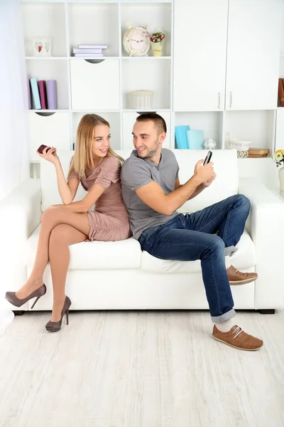 Young couple after quarrel sending to each other messages at home — Stock Photo, Image