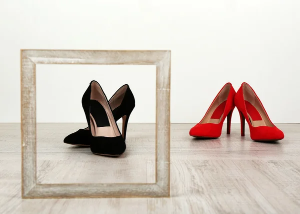 Black and red women shoes with frame on floor — Stock Photo, Image