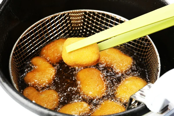 Cutlets in deep fryer — Stock Photo, Image