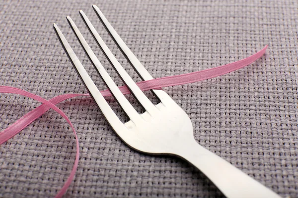 Stages with tying bow on fork — Stock Photo, Image