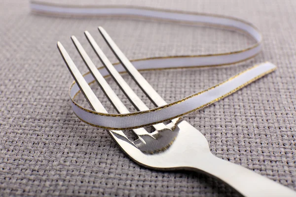 Stages with tying bow on fork — Stock Photo, Image