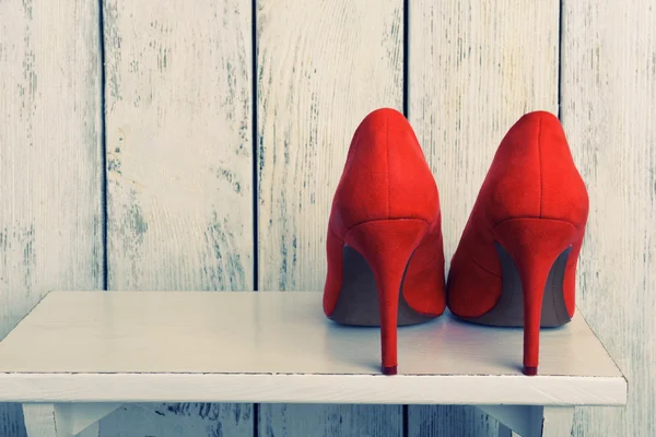 Red women shoes on wooden background